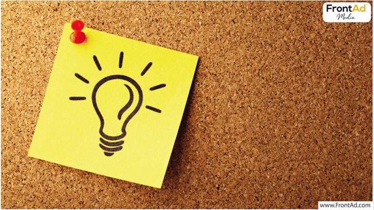 yellow sticky note pinned to a board